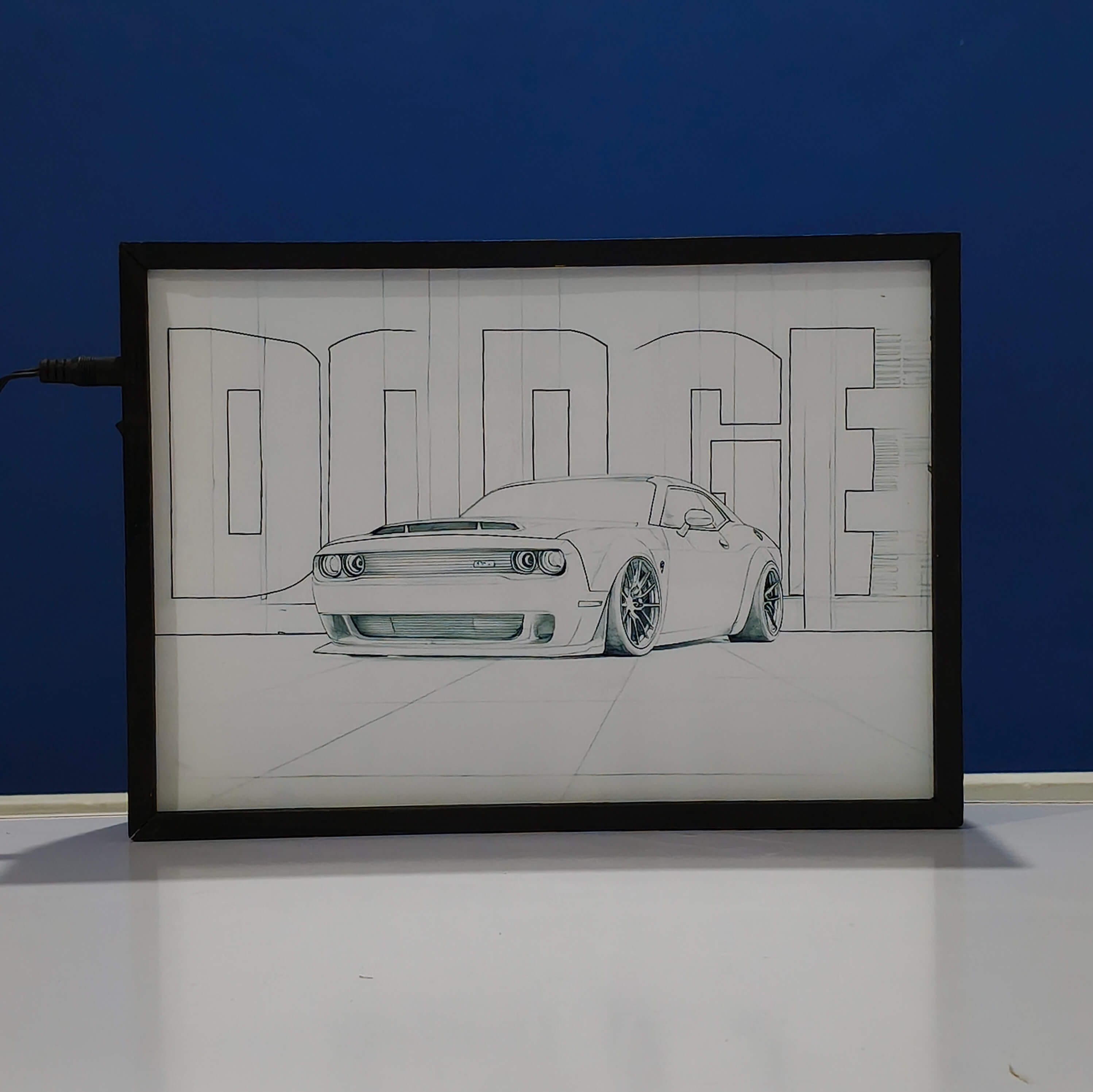 Framed drawing of a Dodge Challenger SRT Hellcat car on a white surface with a blue Backlit frame background